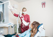 © Ксения Левашова - beautiful woman dentist doing teeth whitening in the dental office
