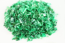 Small Pieces Of Cut Green Plastic Bottles On White Paper