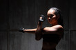 © Jade - Asian Tan Skin Fitness woman exercise stretch arms boxing weight punch in Dark background, studio lighting gradient gray top light shadow low exposure copy space, concept Woman Can Do Sport 6 packs