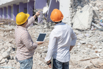 Engineer architect and worker operation control demolish old building.