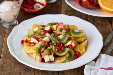 Canvas Print - Salad with various fresh fruits on a white plate   