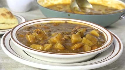 Sticker - Taking a spoonful of beef stew closeup, slow motion