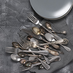 Poster - Vintage silverware and plates on dark grey