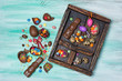 Easter chocolate and quail eggs, bunnies and color dragee in vintage wooden box