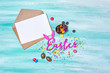 Mock up of blank white card in kraft envelope with pink text of easter and traditional sweeties