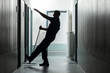 Man Falling While Mopping Floor In Corridor