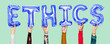 © Rawpixel.com - Hands holding ethics word in balloon letters