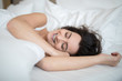 © lightpoet - Beautiful young woman sleeping on bed at bedroom