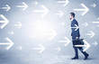 © ra2 studio - Businessman walking with arrows on the background and briefcase on his hand