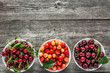 Assortment of fruit. Bowls with fresh cherries. Red sweet cherry fruit, top view.