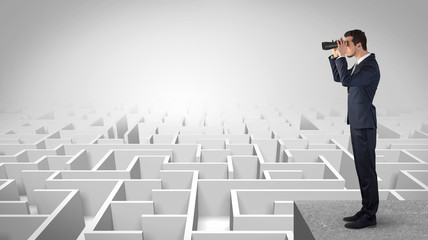 Wall Mural - businessman standing on maze and looking forward to the future concept