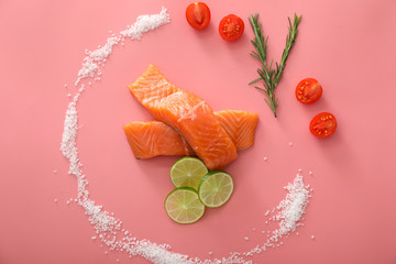 Composition with raw salmon fillet on color background