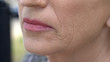 Wrinkled face of pensioner female, anti-age cream, skincare and cosmetology