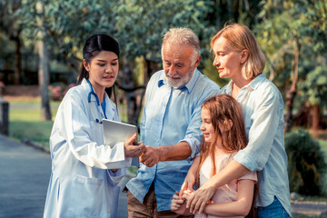 Sticker - Happy healthy family and doctor talking in the park. People healthcare and medical staff service concept.