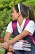 © dtiberio - Colombian School Girl With Ponytail Wearing School Uniform With Notebooks
