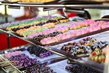 Display Of Delicious Donuts On Trays In A Market.
