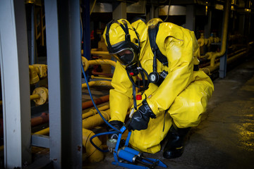 Rescuers in a radiation protection suit.