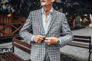 Portrait of  man in gray coat crossing arms while looking forward to .Close up.Business man