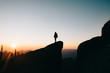 © Forrest Smith - silhouette of woman on top of the mountain at sunset