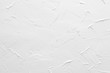 White textured wall. Decorative plastering close-up photo. Surface with stucco daub