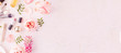© uv_group - Makeup products and make-up brush with pink flowers on pastel background. Panoramic banner with copy space for text. Luxury beauty.