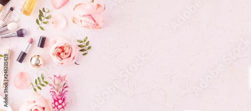 Cuadros en Lienzo Makeup products and make-up brush with pink flowers on pastel background