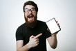 © Vulp - Portrait of a excited bearded man pointing finger on blank tablet computer screen isolated on a white background