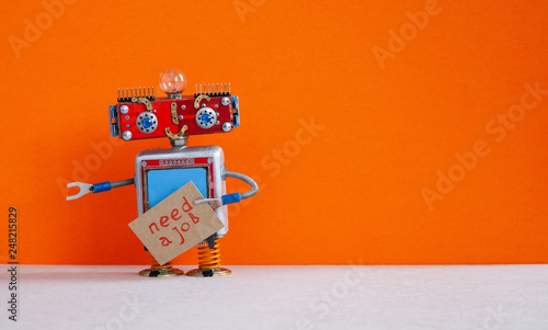 Job search concept. Robot wants to get a job. Funny unemployed robotic character with a cardboard sign and handwritten text Job wanted. Orange background, copy space