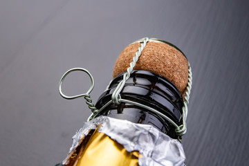 Closed bottle of champagne on the kitchen table. Opening a new bottle of noble beverage.