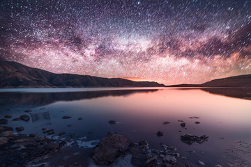 Night landscape, beautiful milky way above the lake.
