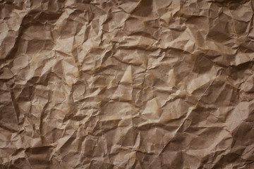 Crumpled brown craft paper texture background.