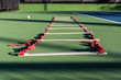 Agility ladder lying on tennis court waiting for next player to improve the footwork skills.