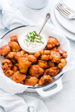 Crispy cauliflower buffalo wings coated in spicy sauce