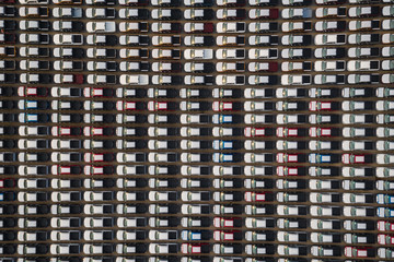 Wall Mural - new cars lined up in the parking lot for distribution international for business sale by large corgo container shipping open sea