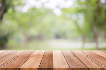 Wall Mural - Empty wooden table with blurred green background with a country outdoor theme,Template mock up for display of product