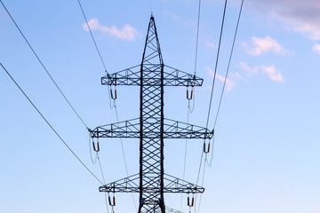 High-voltage power lines at sunset