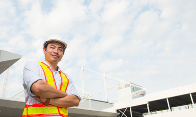 Asian engineer manager, field engineer, foreman celebrate after construction site project complete on time.