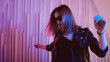 © Ulia Koltyrina - Beautiful girl dancing in retro wave on the neon light