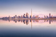 Beautiful colorful sunrise lighting up the skyline and the reflection of Dubai Downtown. Dubai, United Arab Emirates.