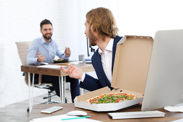 Canvas Print - Office employees having lunch at workplace. Food delivery