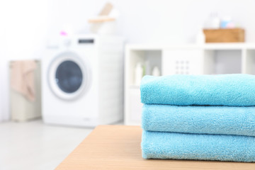 Canvas Print - Stack of clean towels on table in bathroom.  Space for text