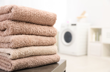 Sticker - Stack of clean towels on table in bathroom.  Space for text