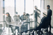 © alfa27 - Side view of blurred silhouettes of businessmen talking in conference room, view through the transparent glass wall