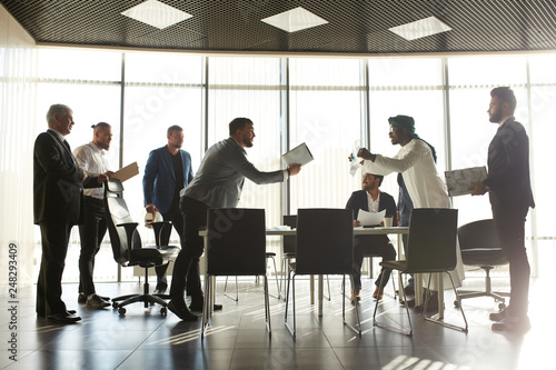 Fotografía mixed race business partners arguing about bad contract