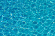 © jollier_ - Blue water in swimming pool background. Ripple Water in swimming pool with sun reflection. Blue swimming pool rippled water detail.