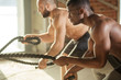 © alfa27 - Two multiethnic shirtless male bodybuilders are exercising with battling ropes. The high intensity and fast nature of training with a rope will effectively develop cardiovascular endurance.