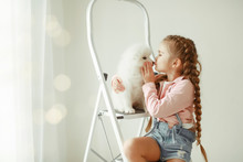 Cute Little Girl With Dog At Home
