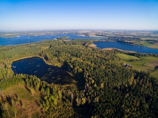 Wall Mural - Aerial view of beautiful covered with forest landscape of Mazury region, Stregielek and Stregiel Lakes in the background, Poland