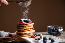 Pancakes With Berries And Maple Syrup And Sugar Powder