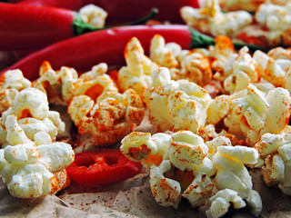 Wall Mural - Spicy hot popcorn with chili pepper. Vegan snack